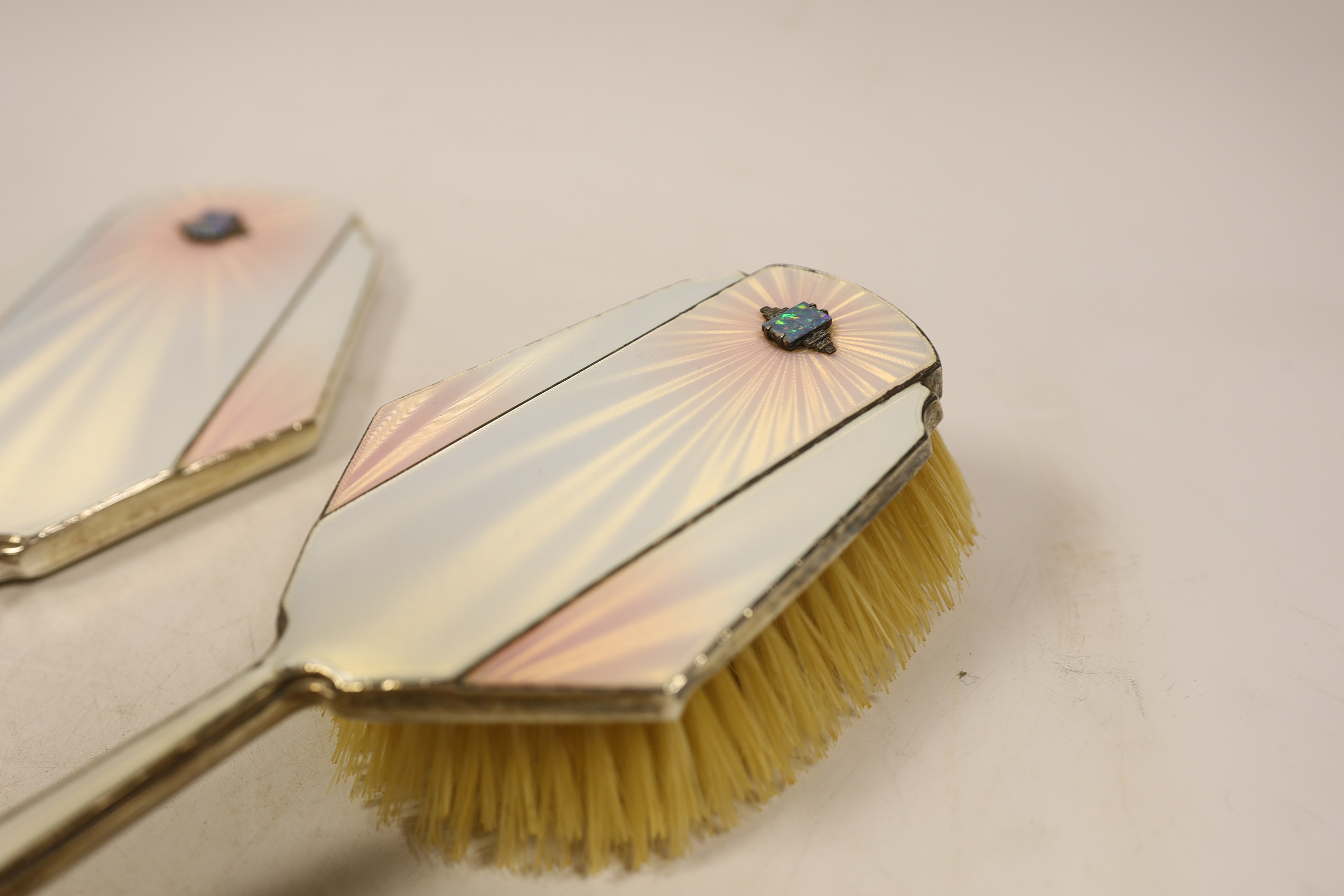 An Art Deco Mappin & Webb silver, enamel, marcasite and black opal mounted six piece mirror, comb (lacking teeth) and brush set, Birmingham, 1935